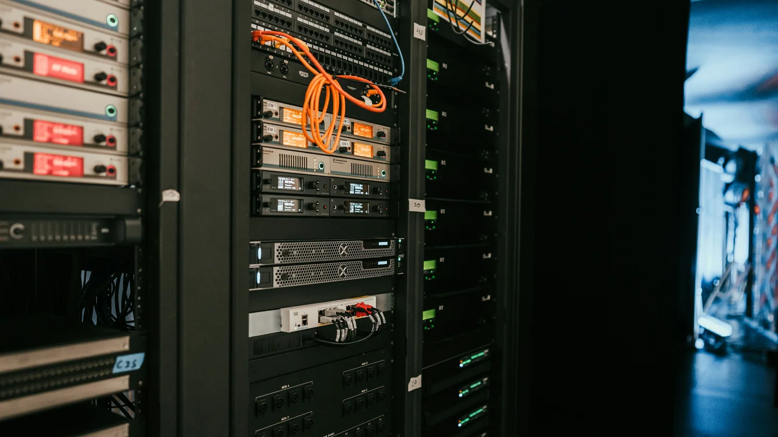 A professional equipment rack with network, audio, and control hardware